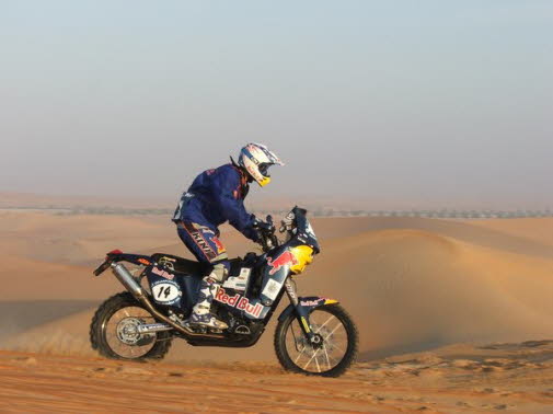 Chris riding in the heat and sand