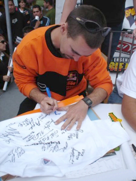 Chris signing a shirt at the Baja 500